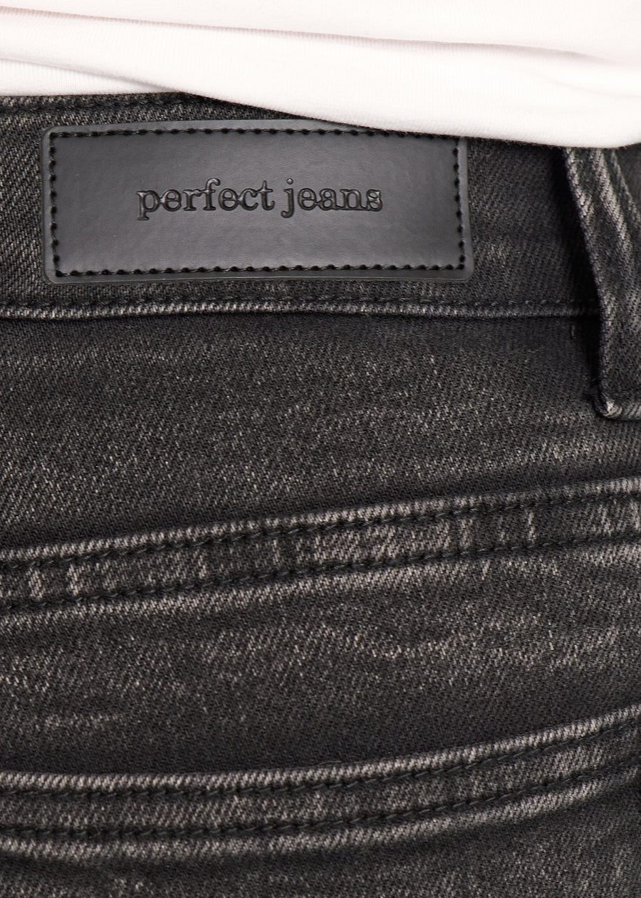 Nærbillede af mørkegrå denim med Perfect Jeans læderpatch bagpå i taljen, på en plus-size model.
