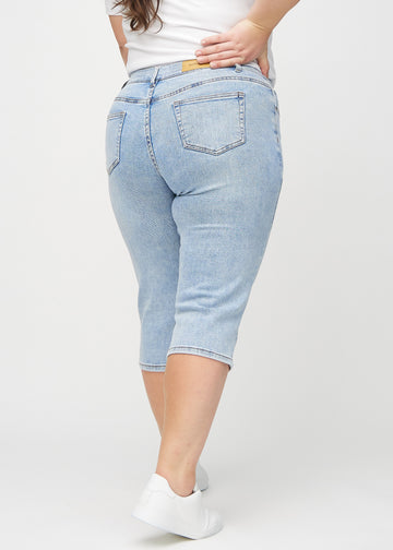 Hellblaue Denim-regular-Capris an einem Plus-Size-Model von hinten gesehen, sodass man das gesamte Produkt sehen kann.