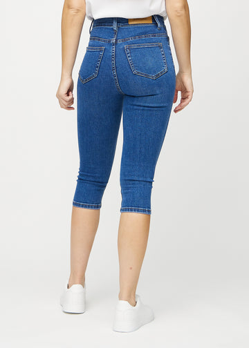 Dunkle Denim-skinny-Capris von hinten gesehen, damit man das gesamte Produkt sehen kann.