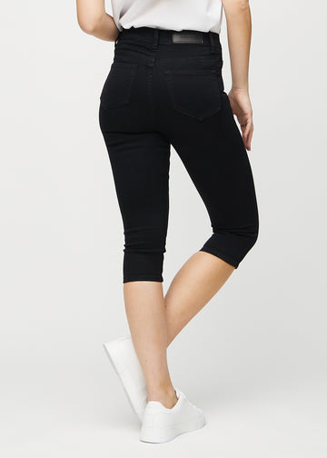Schwarze skinny Capris von hinten gesehen, sodass man das gesamte Produkt sehen kann.