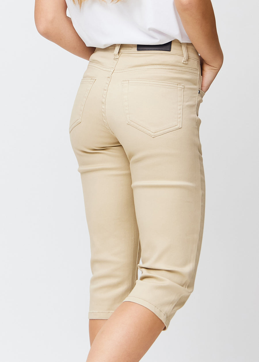 Slim-Capris für Damen aus beigefarbenem Jeansstoff, Farbe Gazelles. Nahaufnahme von hinten an einem Model, zeigt Taschen und Nähte.