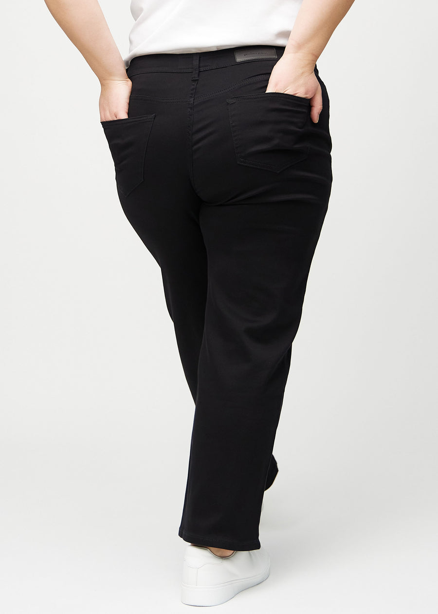 Schwarze loose jeans von hinten an einem Plus-Size-Model gesehen, sodass man das ganze Produkt sehen kann.