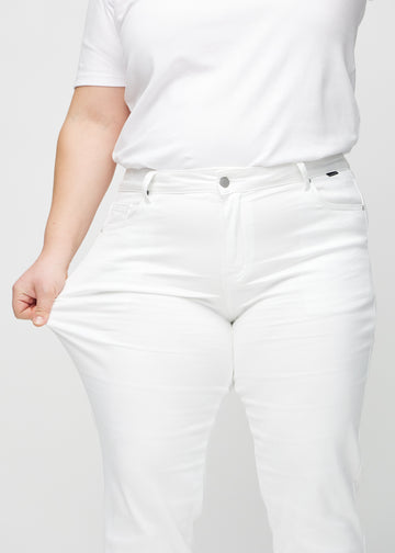 Regular-Jeans für Damen in Weiß, Farbe Marguerites. Ein Plus-Size-Model dehnt den Stoff am Oberschenkel, um den Stretch zu zeigen.