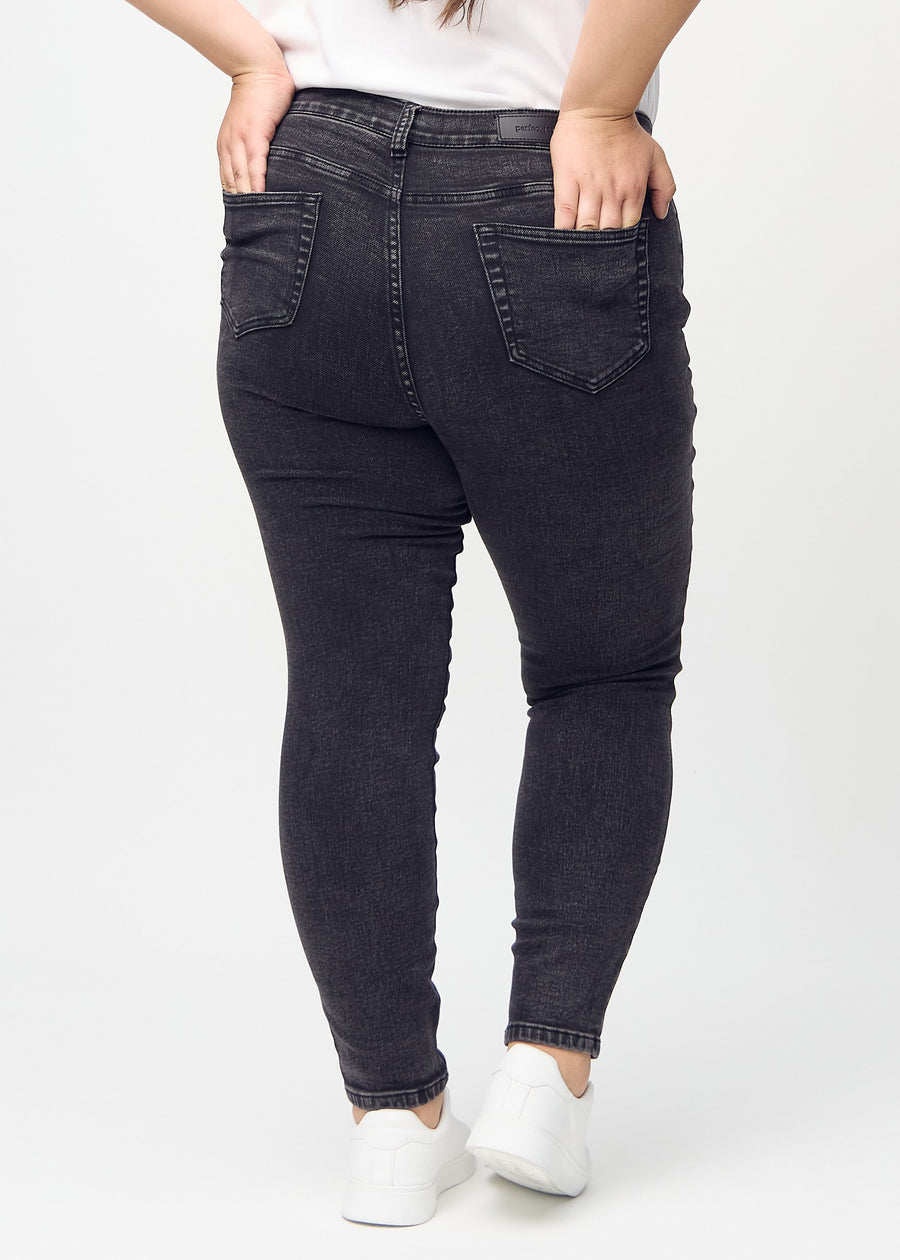Skinny-Jeans für Damen in Dunkelgrau, Farbe Shadows. Rückansicht an einem Plus-Size-Model mit der gesamten Passform.