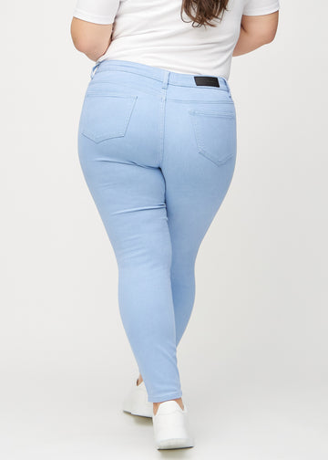 Skinny-Jeans für Damen in Hellblau, Farbe Skies. Rückansicht an einem Plus-Size-Model, die gesamte Passform ist zu sehen.
