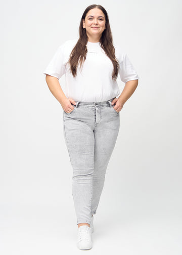 Slim-Jeans für Damen in Hellgrau, Farbe Ashes. Ganzkörperansicht eines Plus-Size-Models in den Jeans.
