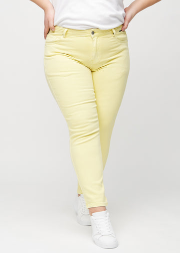 Slim-Jeans für Damen in Hellgelb, Farbe Lemonades. Vorderansicht an einem Plus-Size-Model, körpernah geschnitten mit etwas mehr Platz am Knöchel.