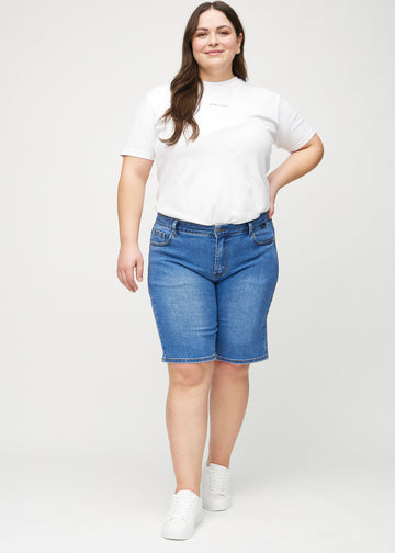 Ganzkörperbild eines Plus-Size-Models in Denim regular middle shorts.