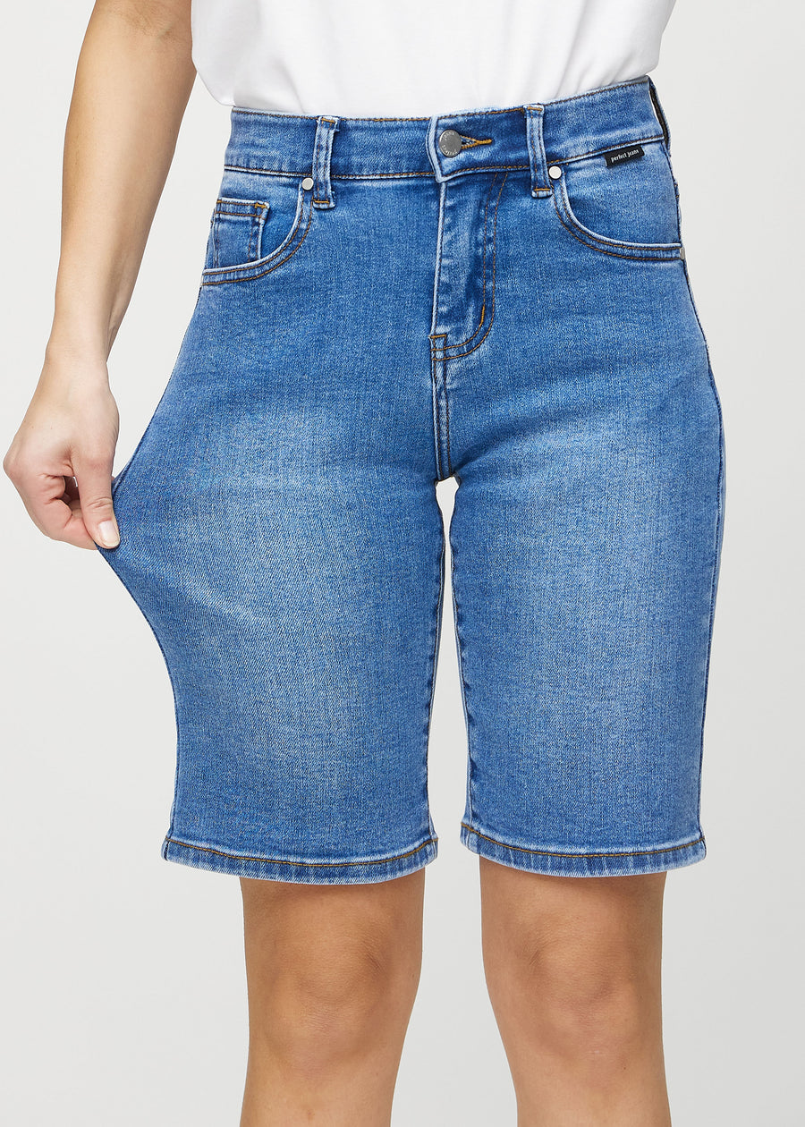 Das Model zieht die Shorts am Oberschenkel auseinander, um den Stretch zu zeigen.