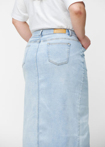 Lang, lyseblå denimnederdel i farven Waves set bagfra tæt på på plus-size model for at vise pasform og detaljer.
