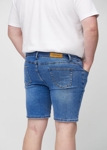 Denim middle-slim Shorts von hinten aus der Nähe an einem Plus-Size-Model gesehen, um Details zu zeigen.